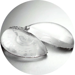 Two clear silicone breast implants displayed side by side