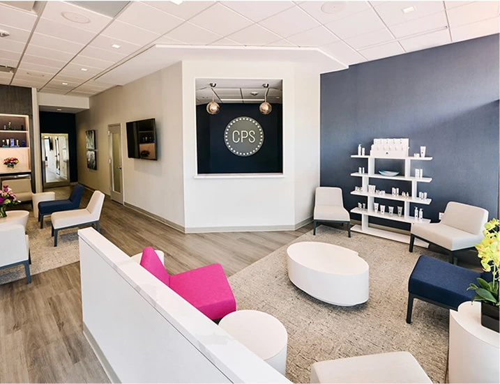 CPS office reception area with modern seating, white oval ottoman and product display